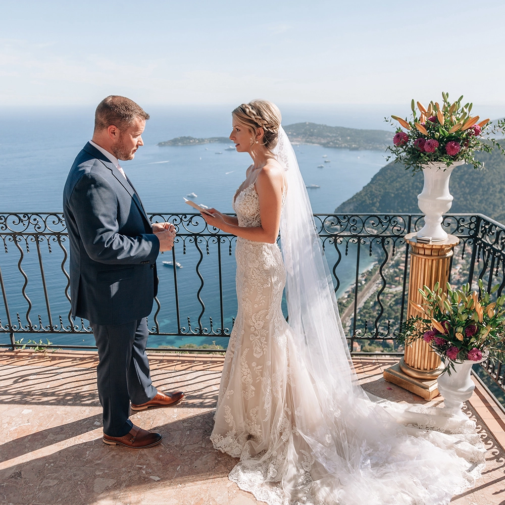 elopement in Monaco The bride reading her vows on a balcony over th eMnaco blue seaa