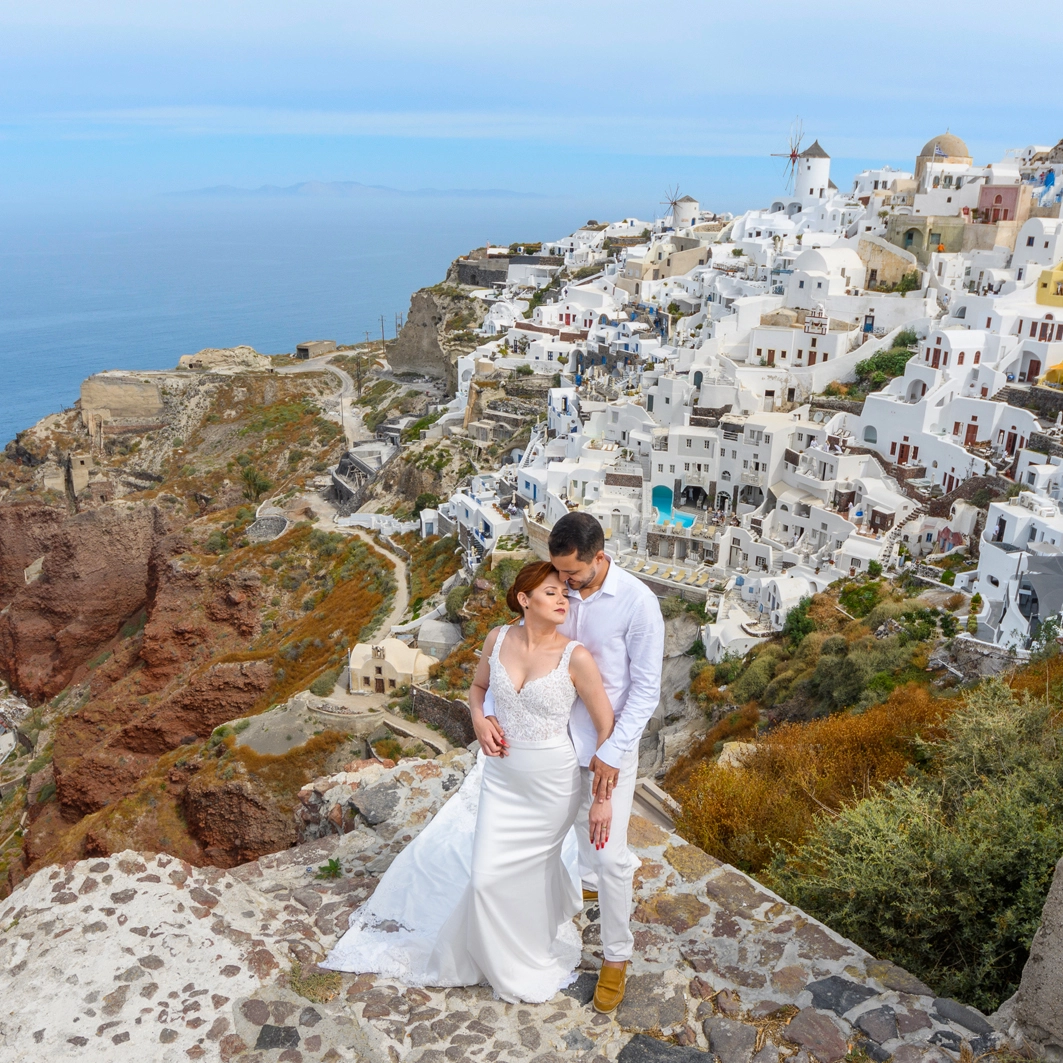 A beautiful view with the bay behind the couple posing for a photo