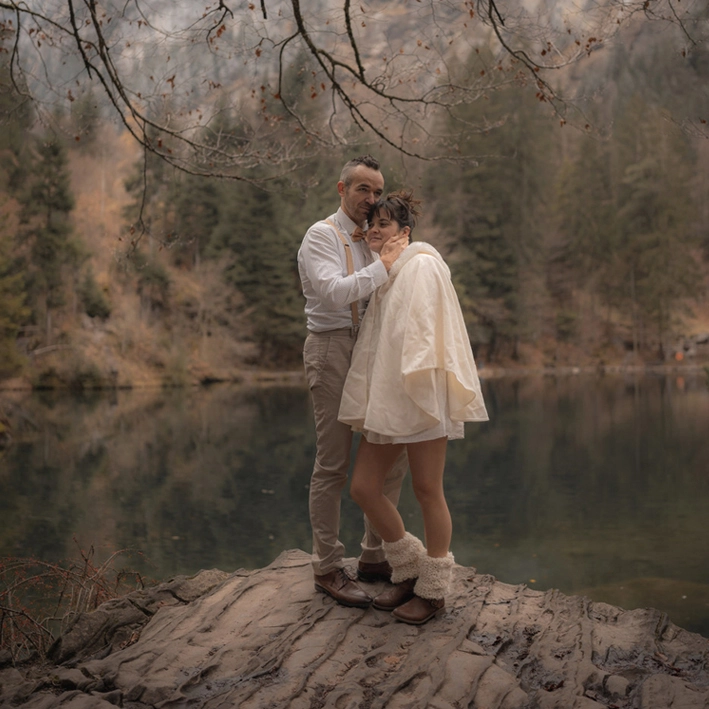 Wedding in Switzerland The couple embraced each other in a love moment by a lake in Switzerland