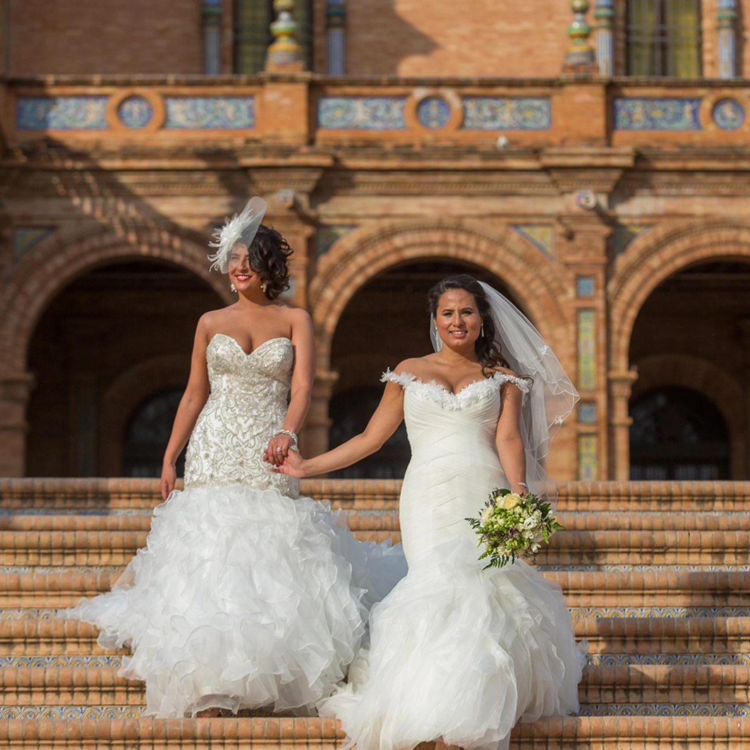 lesbian wedding in europe 2 brides walking holding thei rhands in Spain