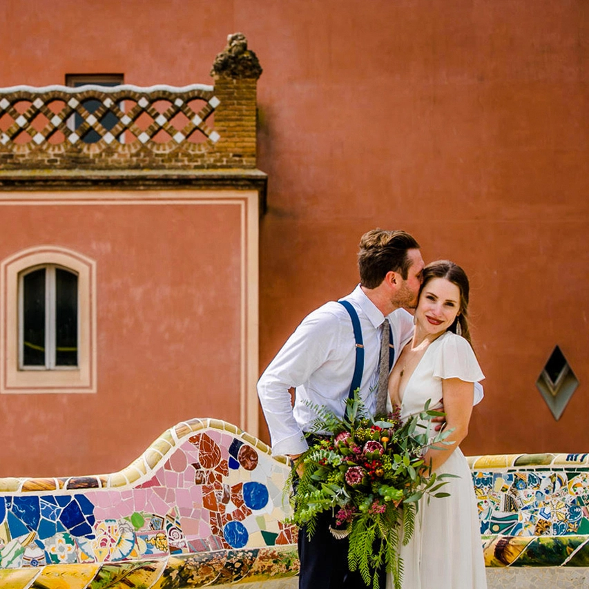 Barcelona elopement The couple in front a vintage house with a typical color