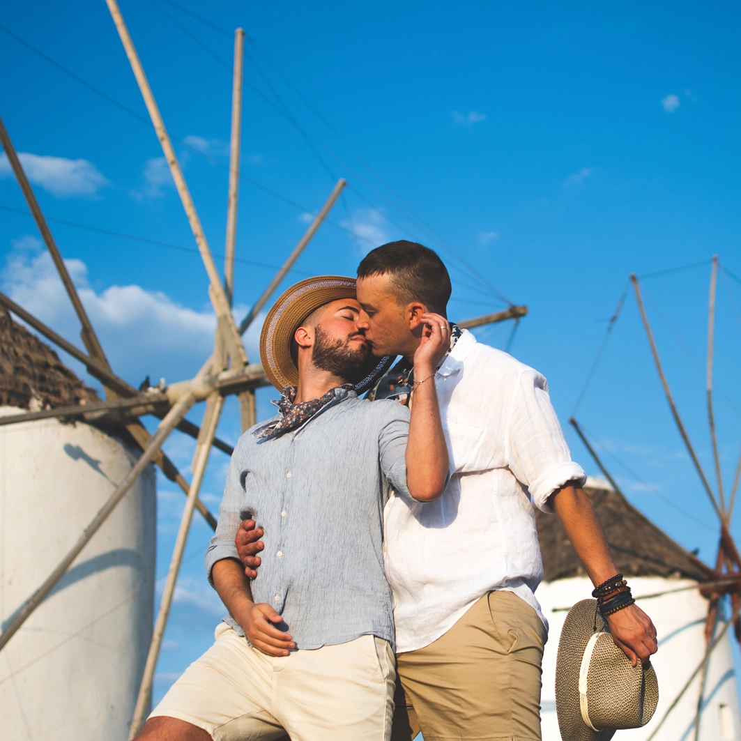 gay wedding package in europe a couple of gay in front of Windmill for their elopement in Mykonos