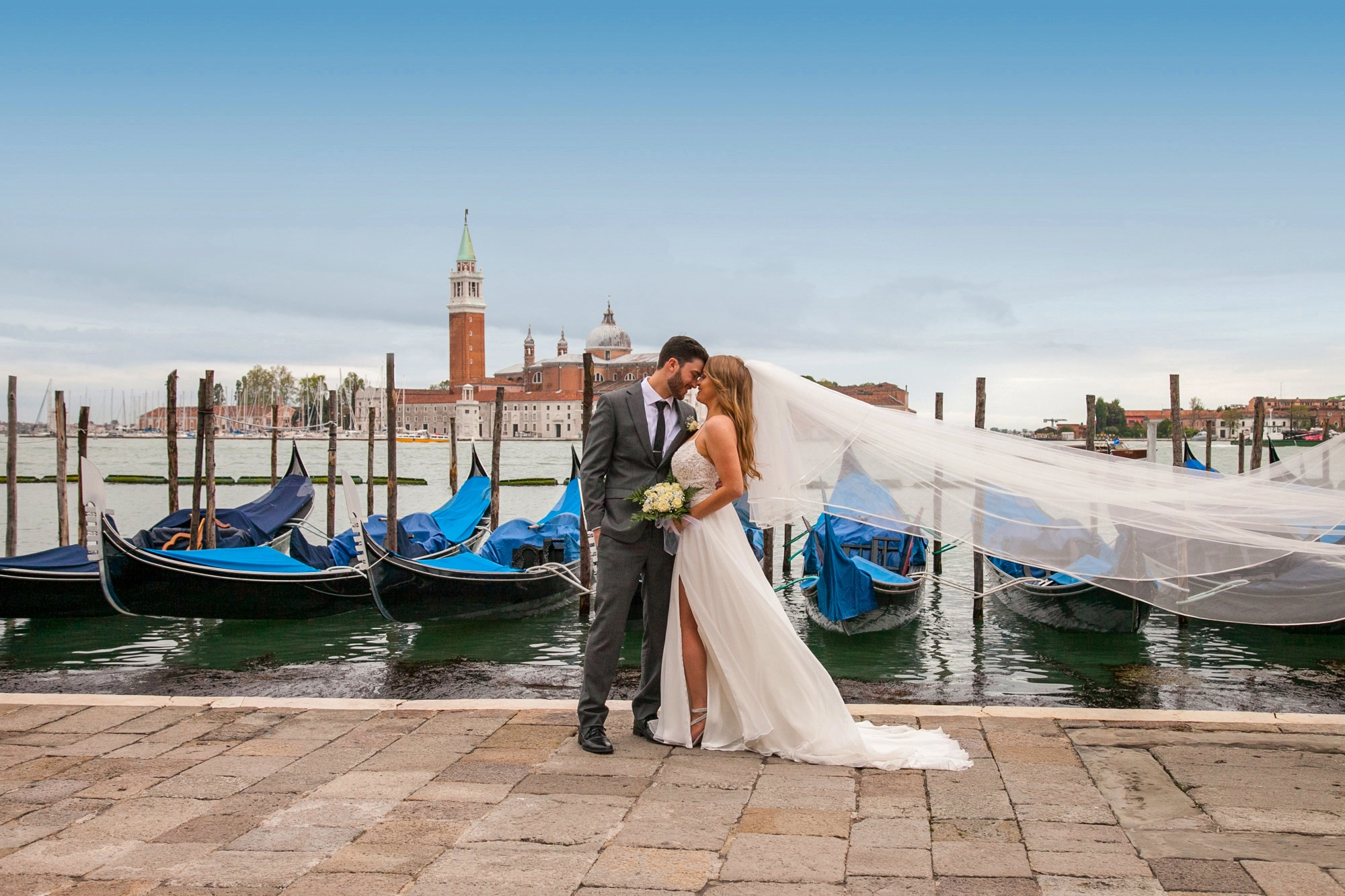 The couple facing each other in front of the canal