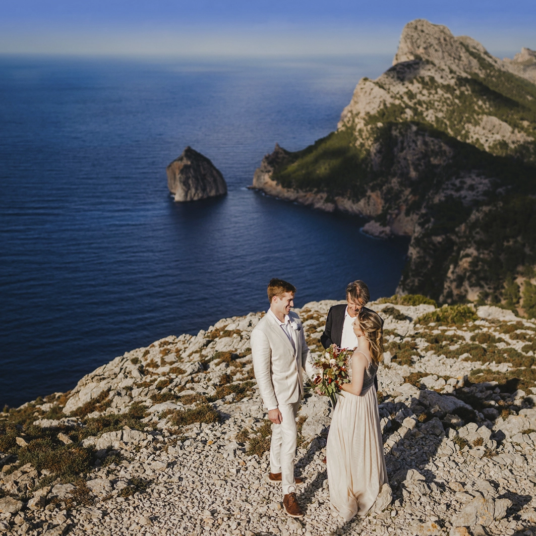 Vow renewal in Spain The couple during their exchange of vows on the cliff, above the see and blue sky