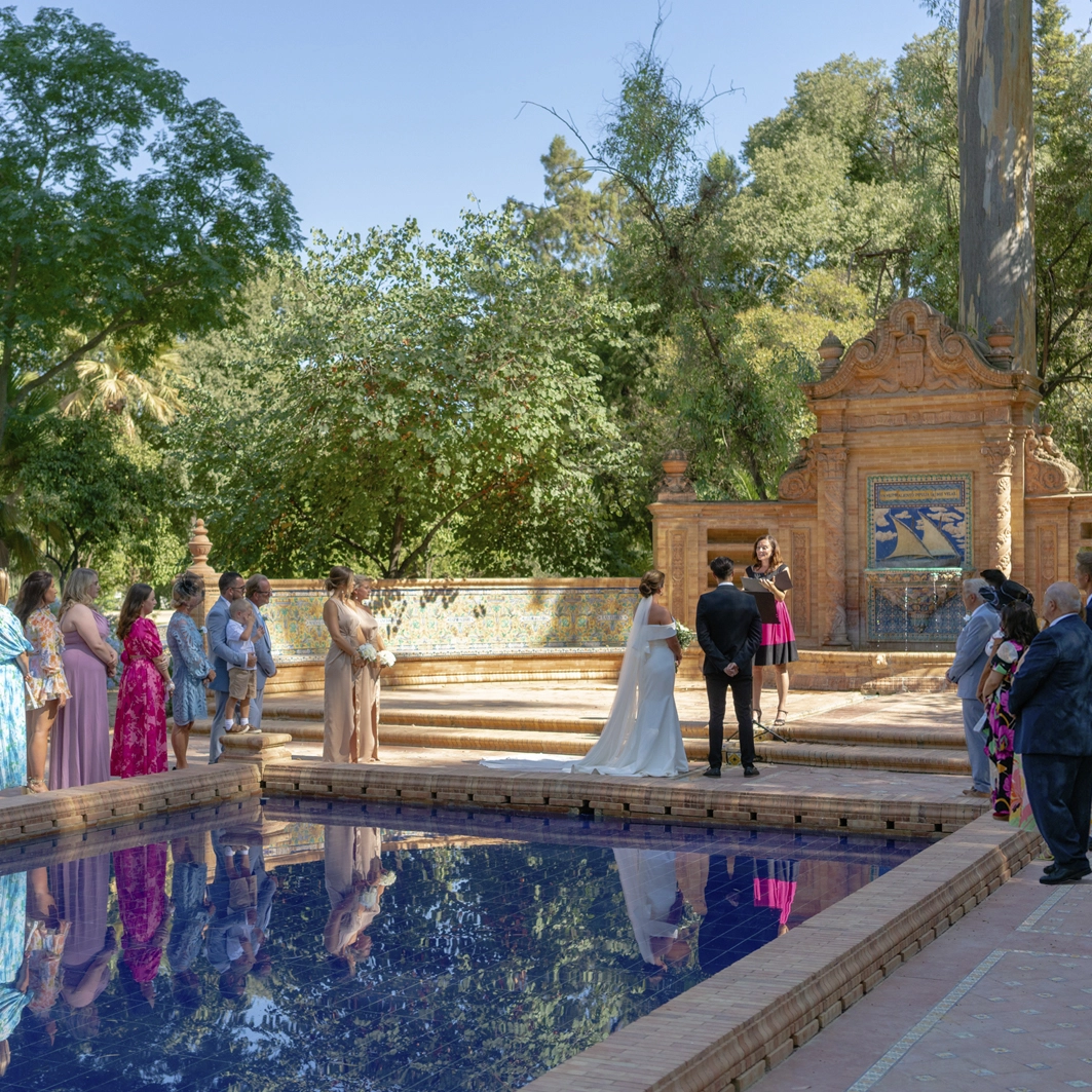 the celebrant face the couple and wedding party. A great lake is a nice location in a Seville garden
