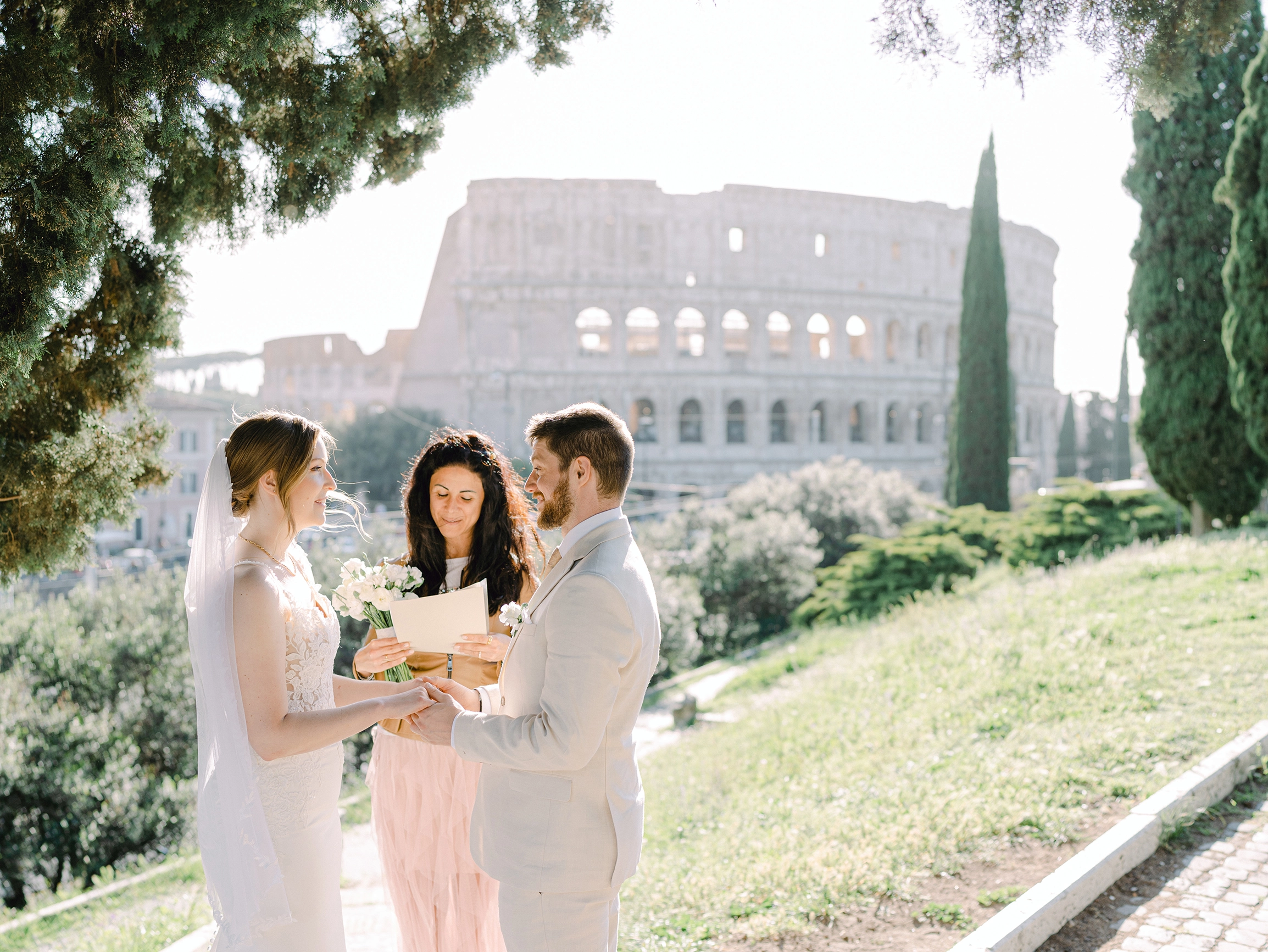 The celebrant of the wedding read the text with the colosseum in background