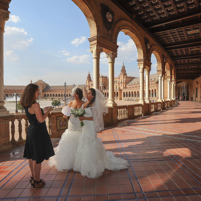 Lesbian wedding ceremony The 2 brides during their wedding ceremony in Seville, facing the celebrant and listening the speech of introduction