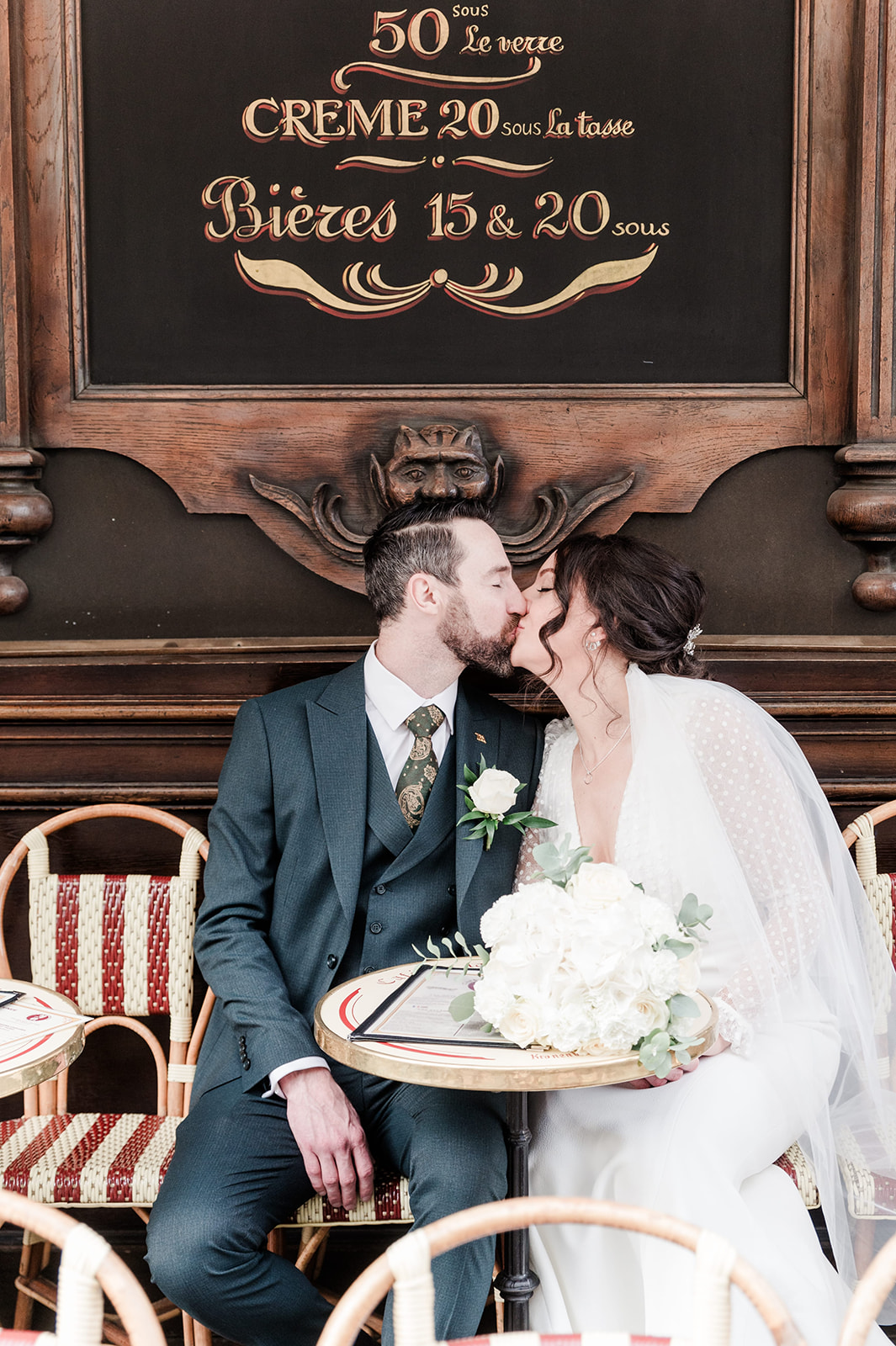 Groom and bride kiss in a romantic parisian cafe A parisian cafe terrace