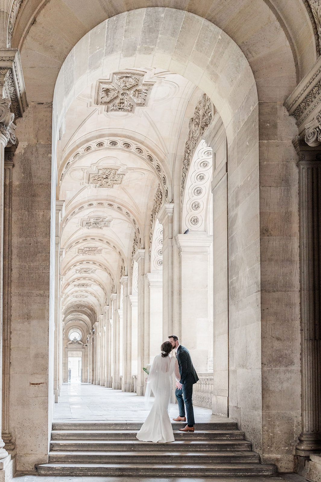 A stunning kiss of bride and room at Louvre corridor A stunning kiss of bride and room at Louvre corridor