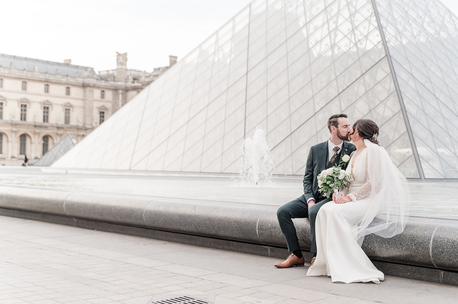 A mandatory kiss at th e bottom of the big Louvre pyramid A mandatory kiss at th e bottom of the Louvre pyramid