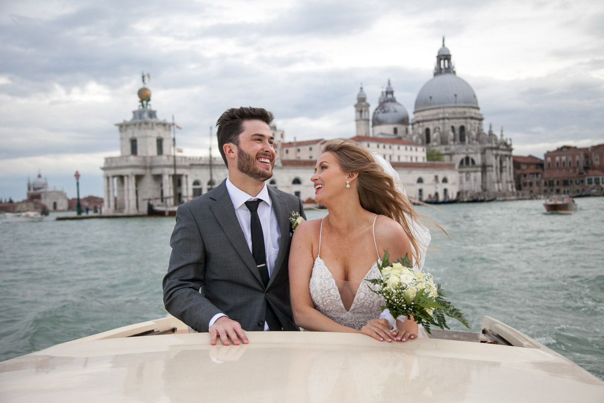 012-elopement in venice-72 the couple cruising on a boat in the channel