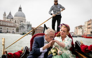 a classical and very romatic kiss on th ehand by the groom
