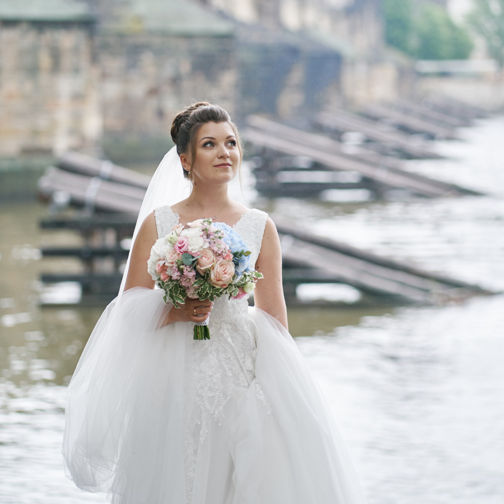 The bride close to the river with her bouquet
