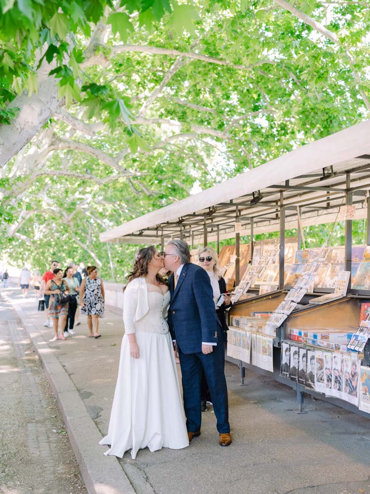 Walking hand to hand along the book shop above the river in Rome