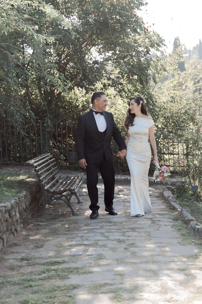 The couple walk hand to hand after the ceremony