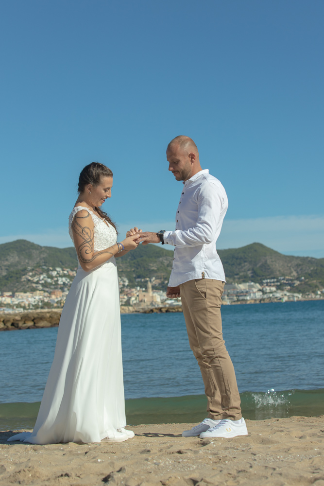The bride facing each other for the vows on the beach