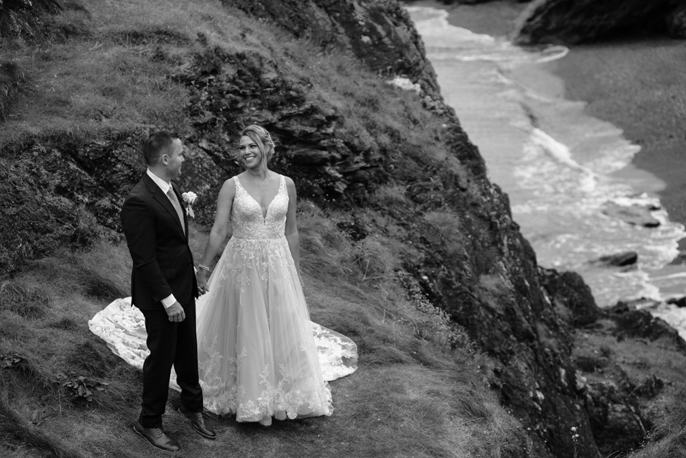 elopement wedding in Ireland-258-114 bride and groom posing above the beach at Black Castle
