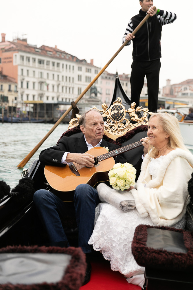 The groom plays a serenade on the gondola to celebrate their renew of vows