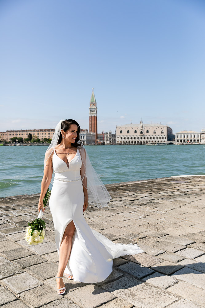 The bride walking over the grand canal in Venice before the wedding ceremony