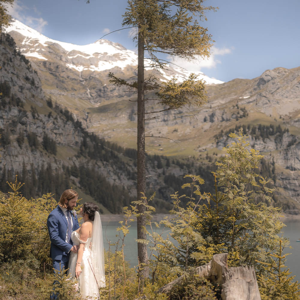 Switzerland elopement package-187-001 The couple facing each other above the lake during the elopement ceremony