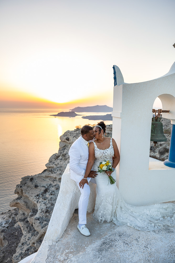 The moment of the kiss after their vows renewal ceremony at Sunset in Santorini