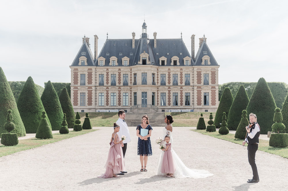 Bride and groom exchanging their rings at the bottom of the eiffel tower in Paris