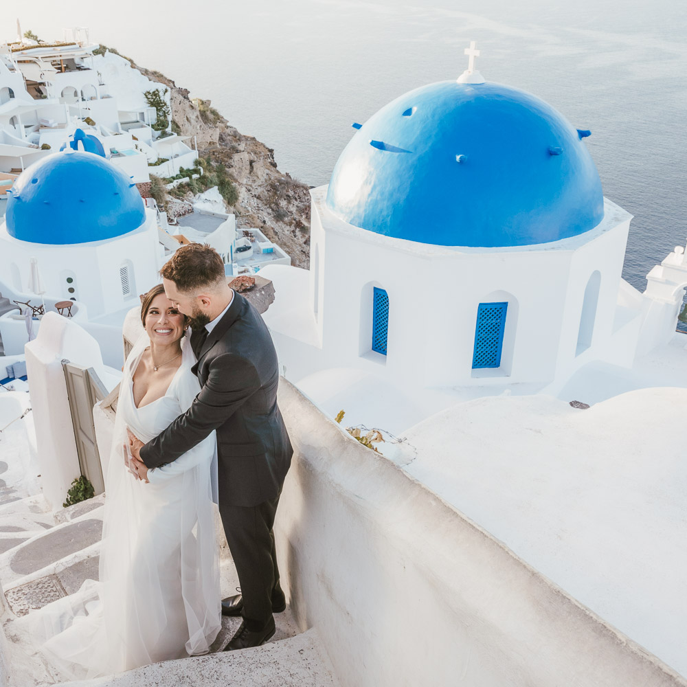 The couple over the Santorini roof top for their elopement