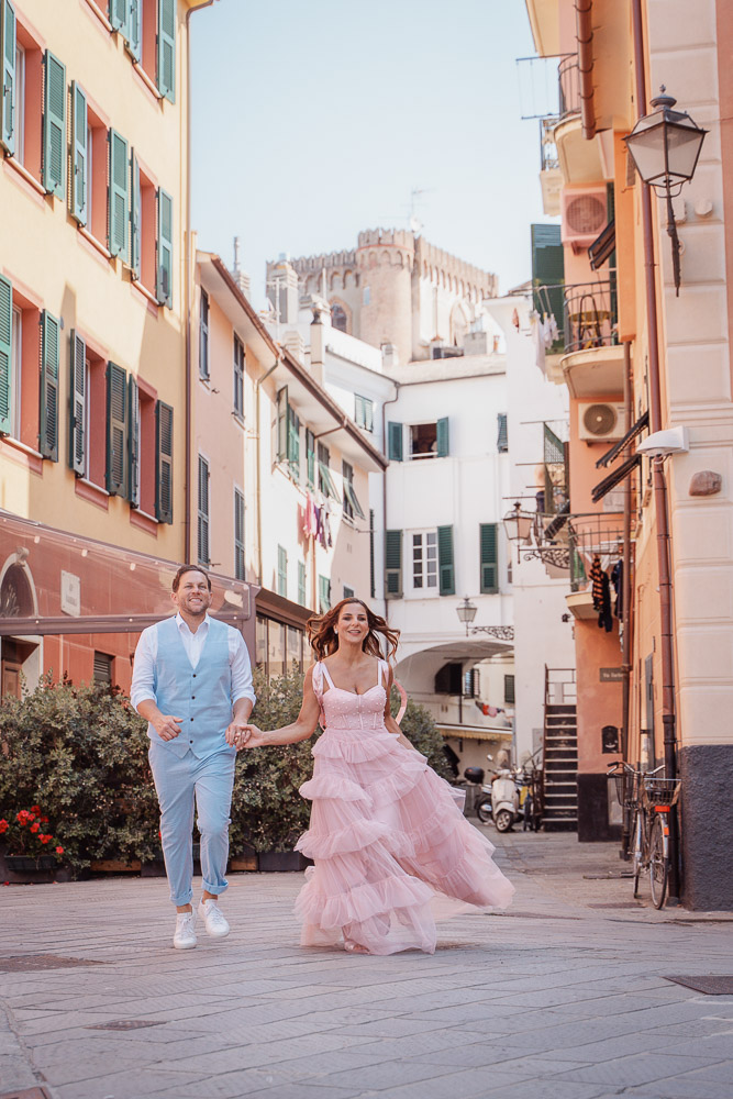 The couple walking hand to hand in the old village of Siestre levante, cinque terre